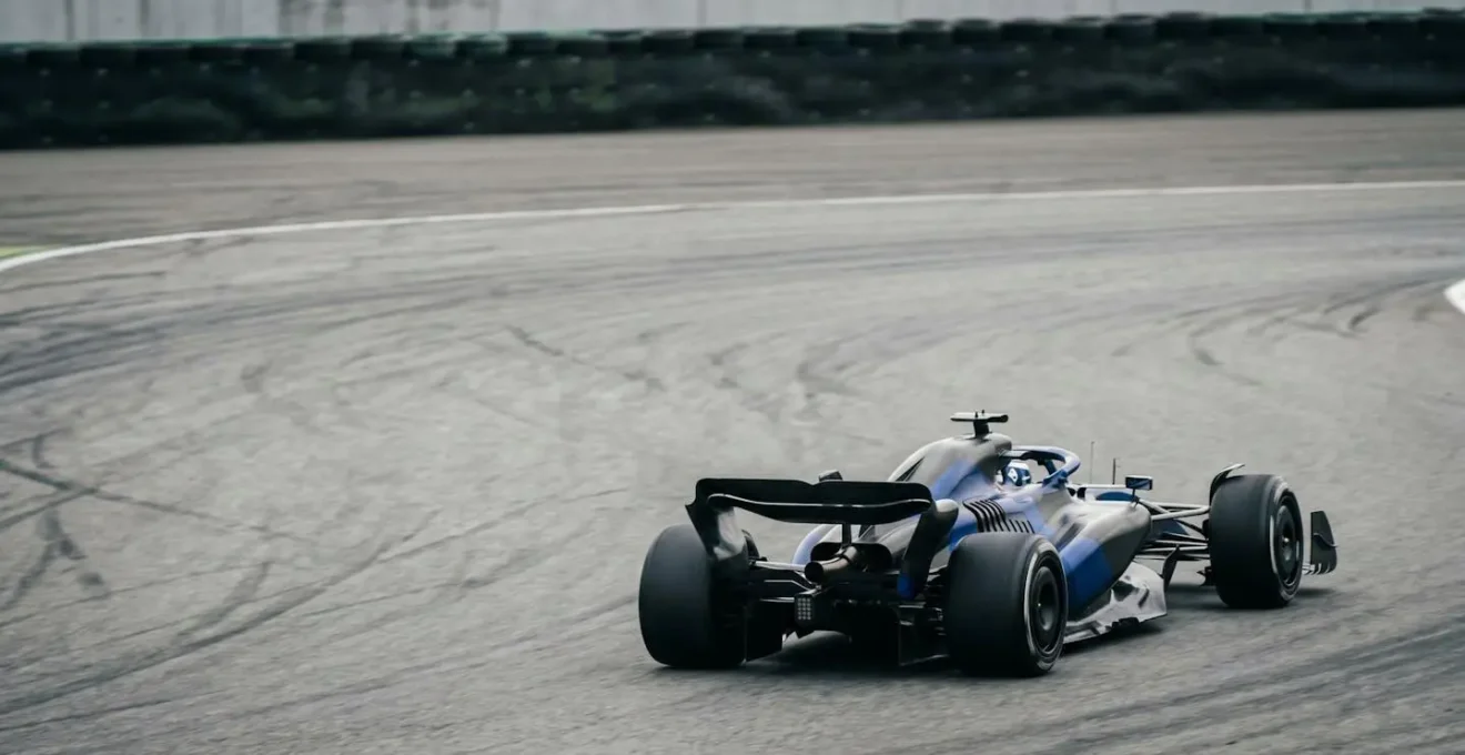 Formula 1 race car creating turbulent aerodynamic wake during high-speed cornering