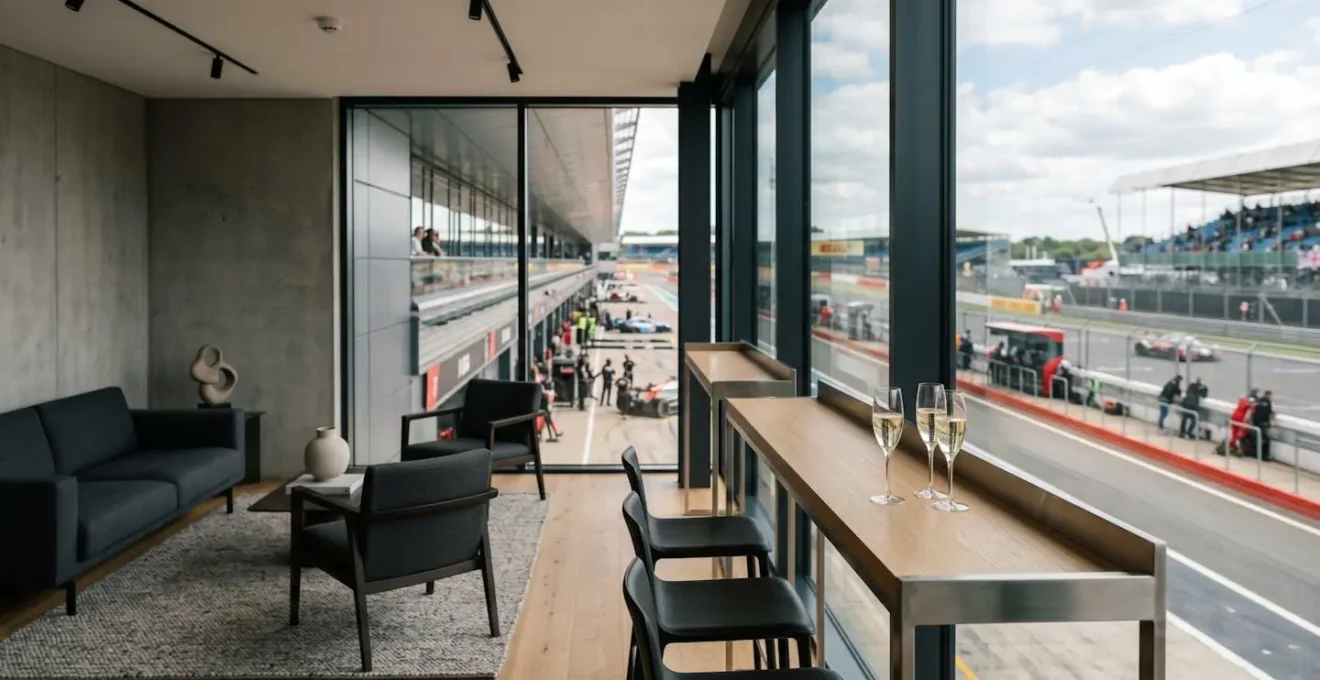 Premium F1 Paddock Club hospitality suite overlooking pit lane with elegant setting capturing the exclusive racing atmosphere