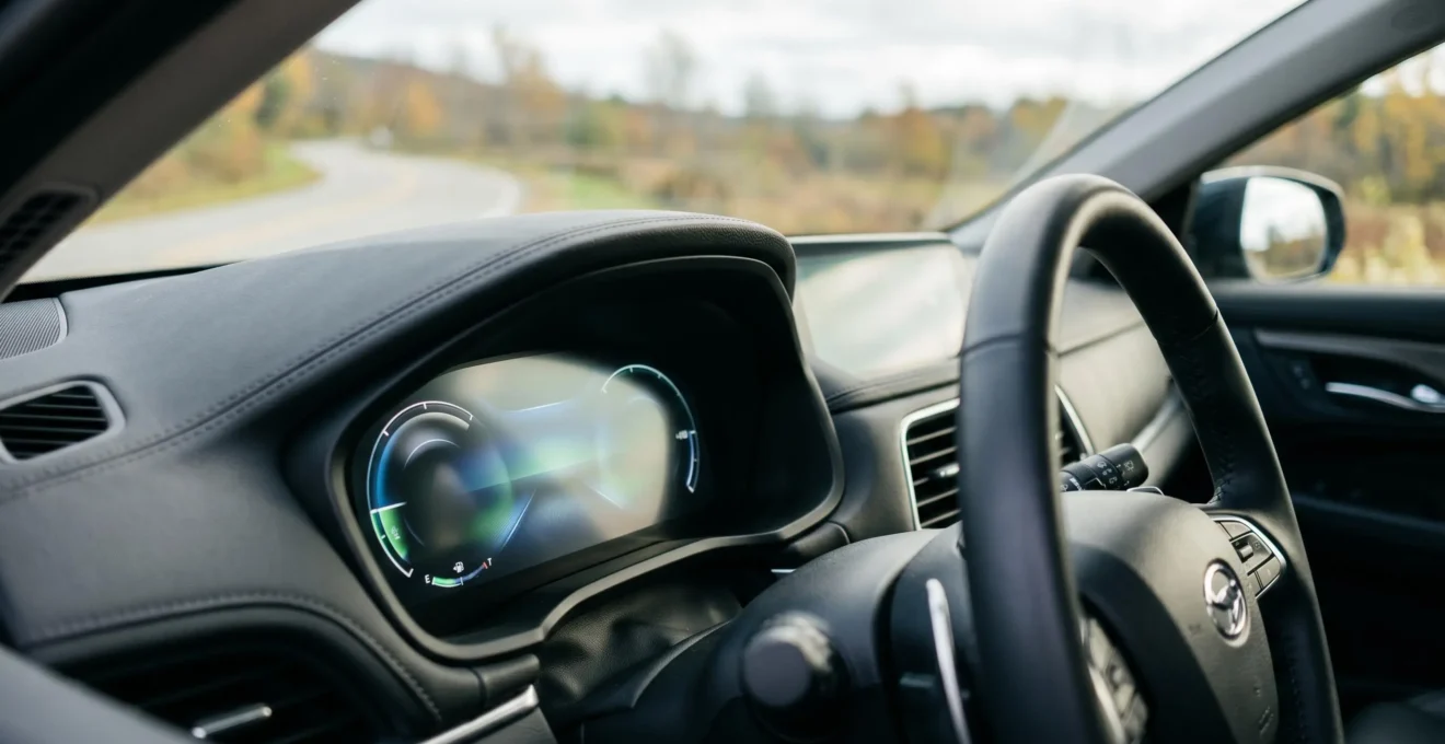 Close-up view of a modern hybrid vehicle dashboard showing fuel efficiency display in real-world driving conditions